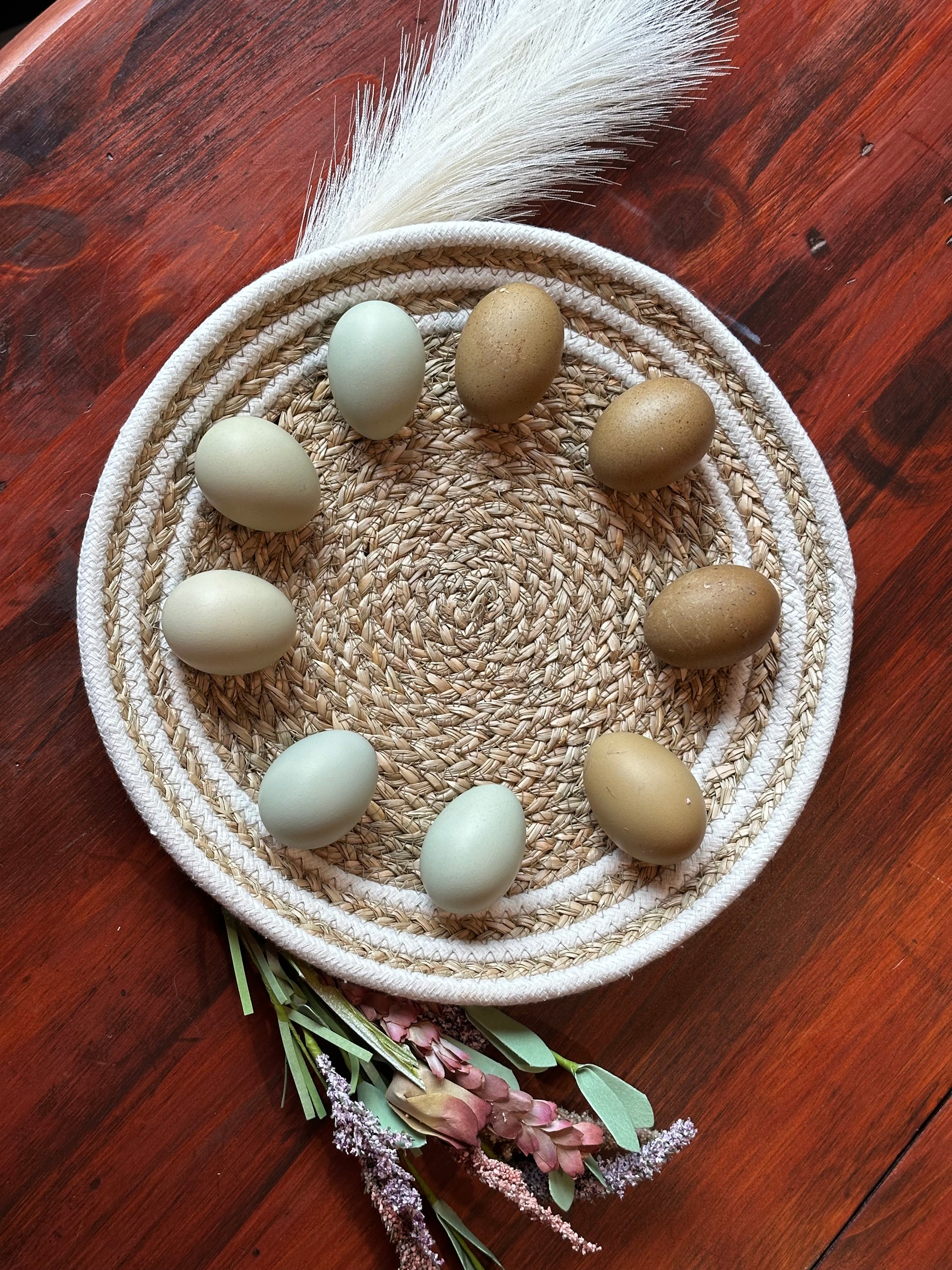 Woven basket with eggs on a wooden surface