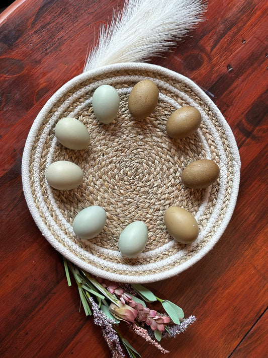 Woven basket with eggs on a wooden surface