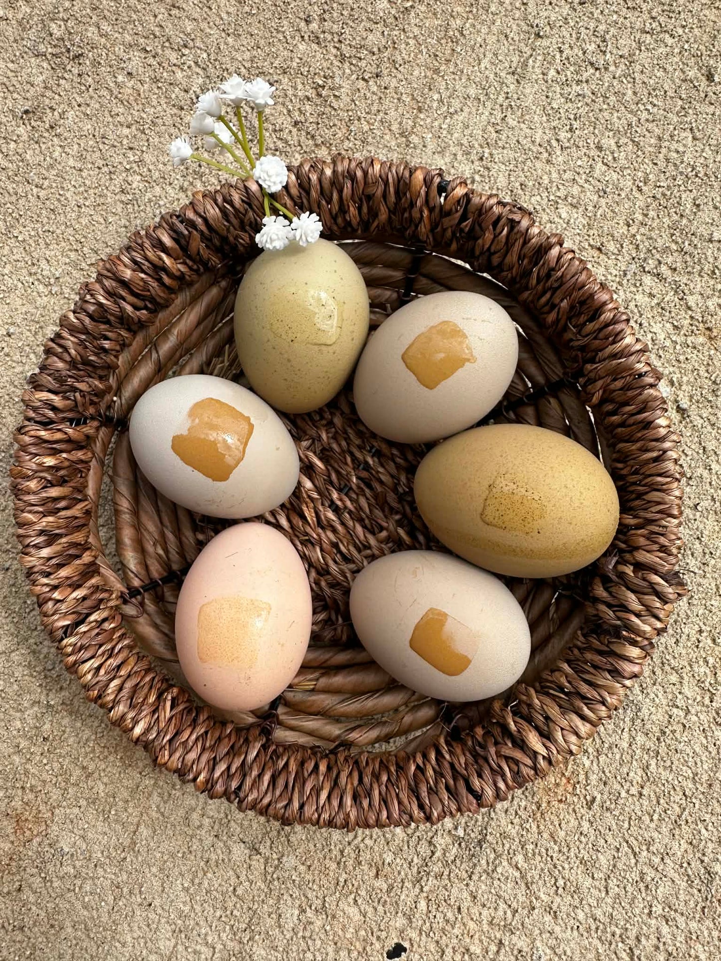 Decorative eggs with water marks to show heavy bloom on a woven basket
