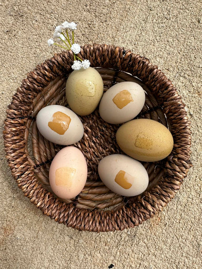 Decorative eggs with water marks to show heavy bloom on a woven basket